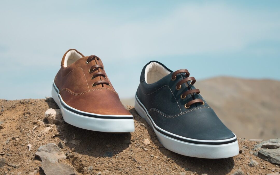 two unpaired brown and blue leather low-top sneakers